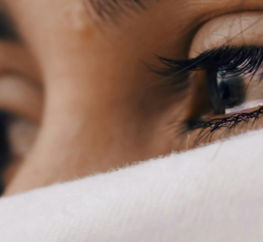 shallow focus of a woman's sad eyes
